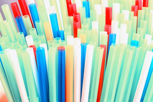 Abstract colorful background. Background from cocktail tubes close up. Soft focus. Cocktail tubes of different colors close up.Close-up of straw tubes.