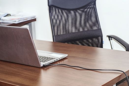 The office, in the office table and chair, on the table is a computer connected to the network.Workplace with notebook laptop .