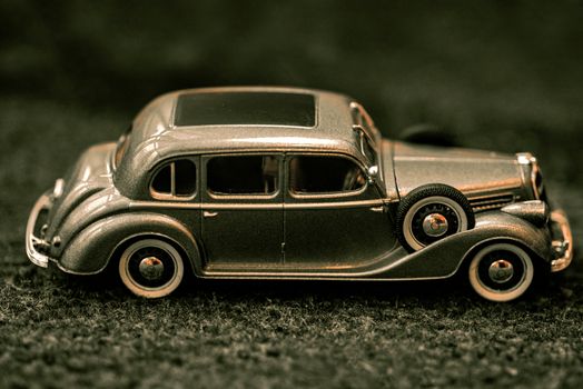 Car close-up.Dark grey vintage car . Retro car's close up.Retro car on a dark background. Car close-up.