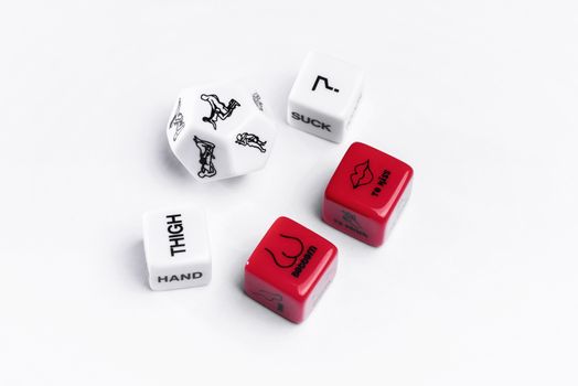 Cubes with Kama Sutra poses for sex games. Playing cubes of red and white color for sexual games.Game stones for sex games. Adult toys for sex games. White and red stones.