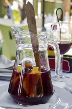 Jug of sangria on a white table. Glass goblets. Concept of relaxation and enjoyment of life