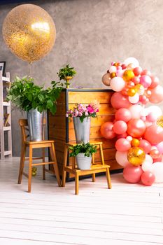 On the wooden surface laid out tools for flower bouquets: scissors, roses, colored ribbon, roses.