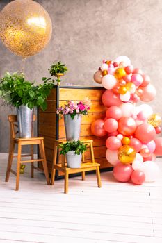 On the wooden surface laid out tools for flower bouquets: scissors, roses, colored ribbon, roses.