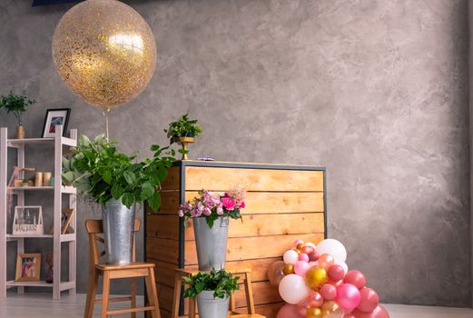 On the wooden surface laid out tools for flower bouquets: scissors, roses, colored ribbon, roses.