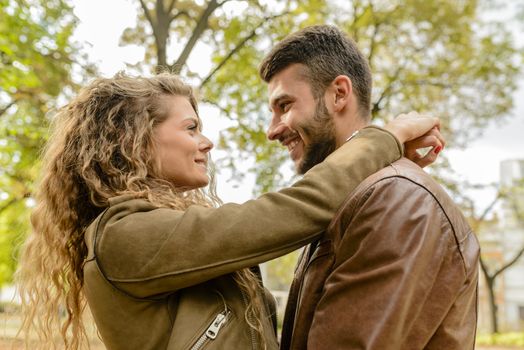 Beautiful young woman hugging her boyfriend and showing love emotions. Romantic moment