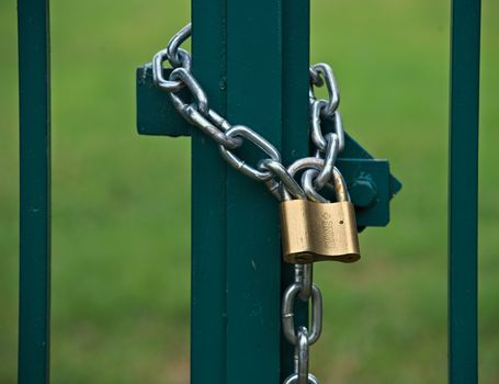 Padlock with chain locking gate on a field