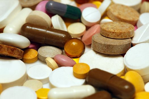 Assorted colorful pills and capsules close up, horizontal, selective focus, medical concept