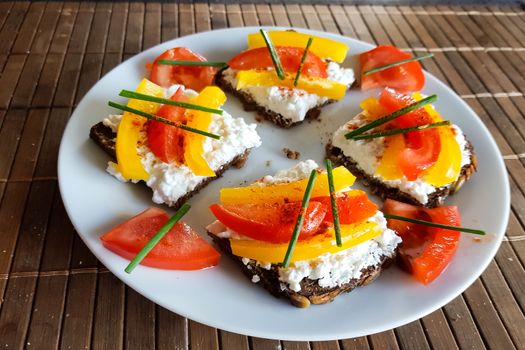 Black bread with quark, tomatoes and yellow pepper