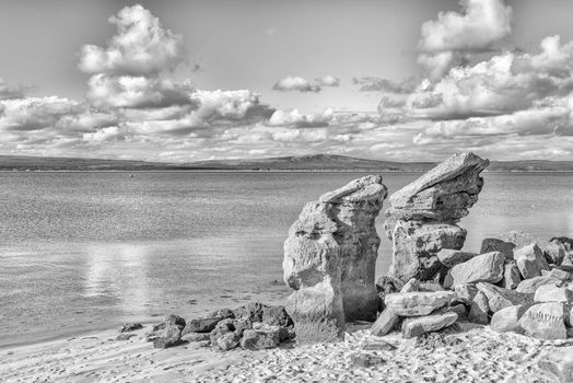 Rock formations on the Preekstoel beach in the Langebaan Lagoon on the Atlantic Ocean coast in the Western Cape Province. Monochrome