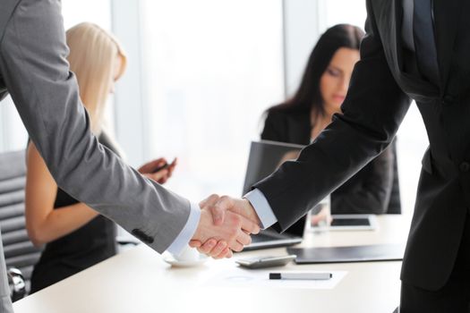 Business people shaking hands finishing up a meeting close up view