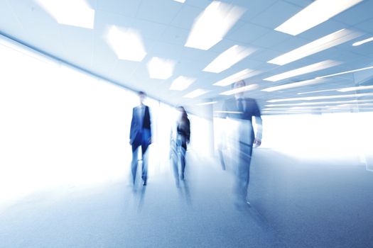 Blurred image of business people walking together in office