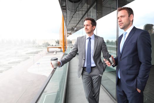 Business people having coffee break at the balcony of office building