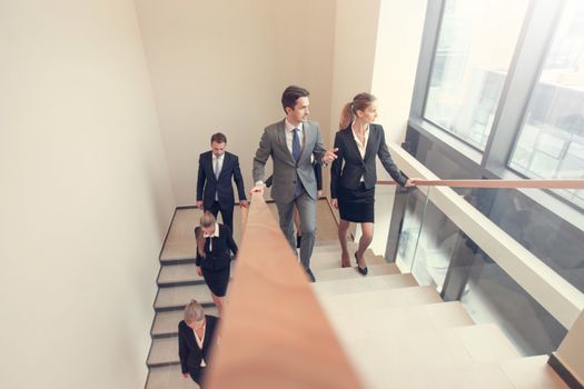 Business people walking the stairs inside building