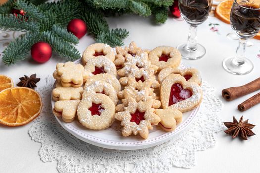 Traditional Linzer Christmas cookies filled with strawberry jam and dusted with sugar