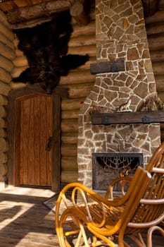 country style interior in hunter chalet with fireplace.