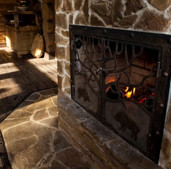 country style interior in hunter chalet with fireplace.