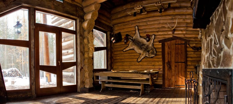 country style interior in hunter chalet with fireplace.