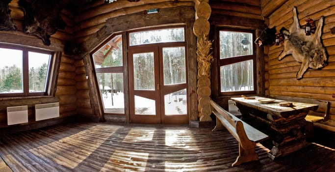 country style interior in hunter chalet with fireplace.