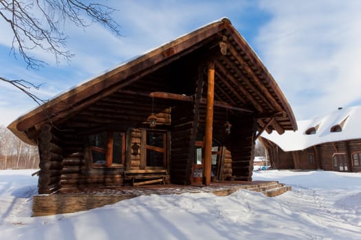 beautiful chalet of wooden frame in the winter landscape