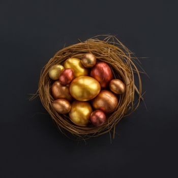 Happy Easter holiday greeting symbol stylish natural wooden grass nest with golden quail eggs on black background