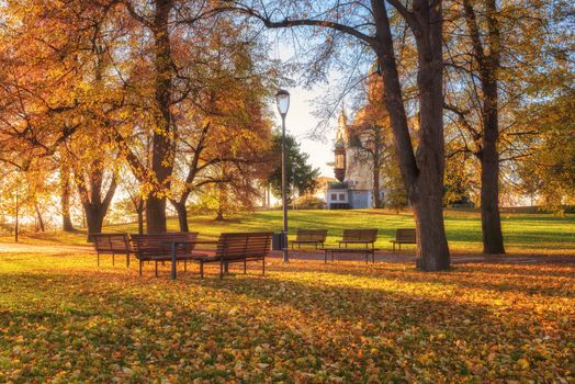 Golden autumn in Prague, famous tourist destination Letna park (Letenske sady) in sunlight with Hanavsky pavilion and nice place for relax, Czech Republic