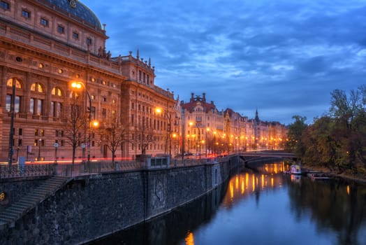 Embankment of Prague historic district, beautiful night cityscape with building of National theatre, Czech Republic