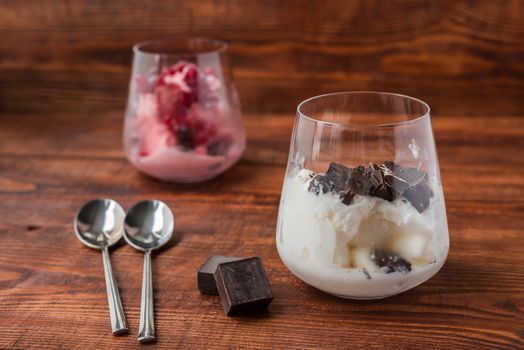 Dessert for couple. Vanilla ice cream with chocolate and strawberry ice cream with red currant