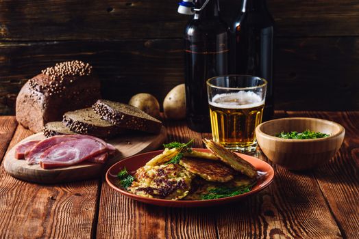 Glass of Beer with Potato Pancakes, Smoked Meat and Rye Bread.