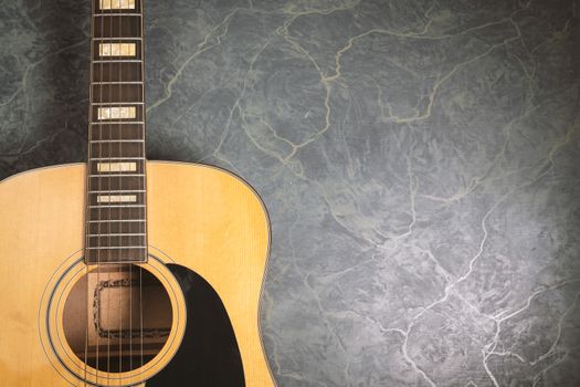 acoustic guitar on green marble background,music concept.