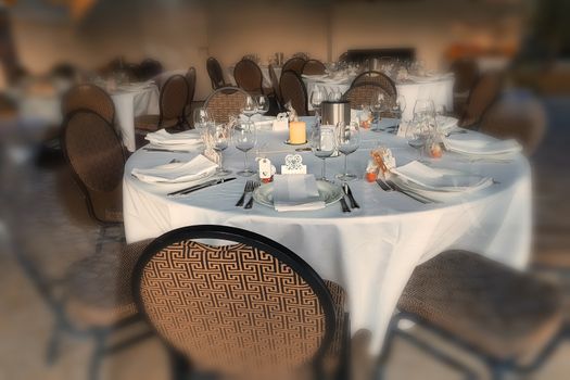 Festive table in a restaurant for a big family celebration with blurred background.