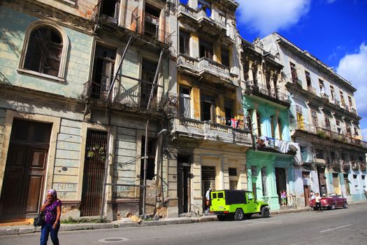 Havana, Cuba - January 10, 2019: Vintage cars moving on the streets of colorful Havana. A great variety of old cars exist In Cuba. On the streets cars from the first half of the 20th century can be found in magnificent conditions, which takes back in history and make the old atmosphere of the cities.