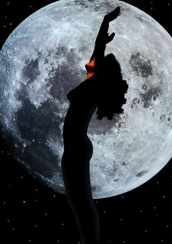 attractive silhouetted nude woman holding her hands up to the moon giving gratitude to the heavens in a yoga pose with a cloudy background