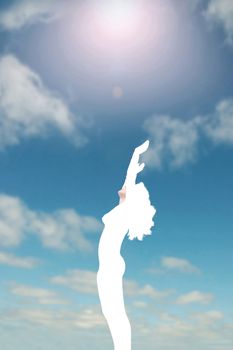 attractive silhouetted nude woman holding her hands up to the sky giving gratitude to the heavens in a yoga pose with a cloudy background