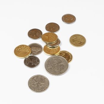 some Malaysian Ringgit coins on a white surface