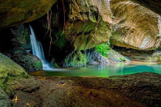 Hidden oasis featuring a waterfall and plunge pool paradise with cave and rock texture patterns in the Macquarie Pass National Park