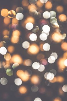 Retro bokeh lights on a dark background with glittering blurs in various colors