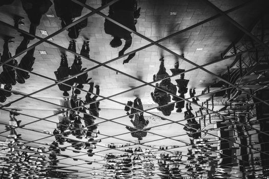 People silhouettes upside down walking on the street