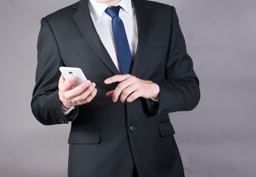 Close up of a successful businessman using mobile smart phone