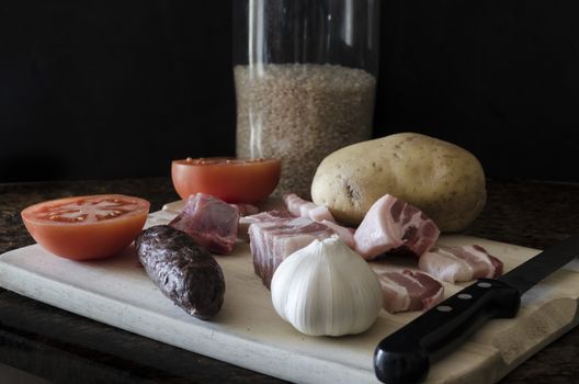 Baked rice ingredients rice, tomato, potato, bacon, pork rib and blood sausage