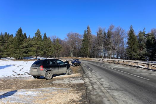 Two cars damaged by crash accident on side of the road