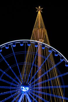 Orange and blue christmas lighting installed on tower and big wheel