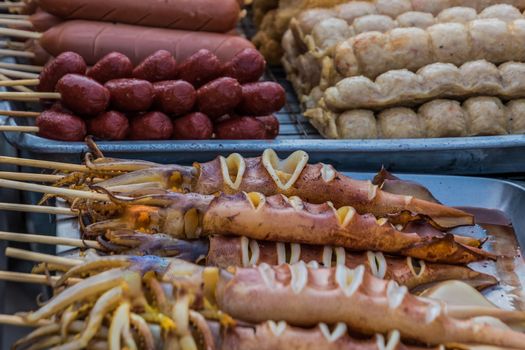 Squid sold on Thai street food market on stick
