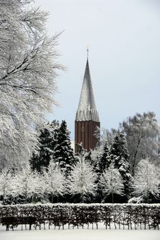 Sad white and grey winter scenary public park and church