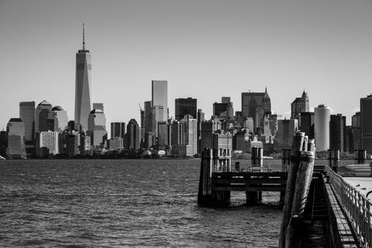 Landing pier at Liberty Island in front of New York skyline Black and White