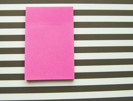 Red message sticker on black and white striped background, business objects.