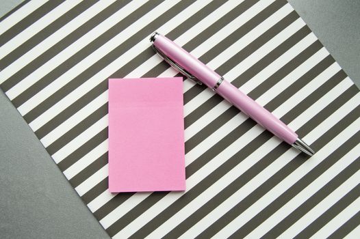 Flat lay, top view office workplace background. Black and white stripes, stickers, fountain pen.