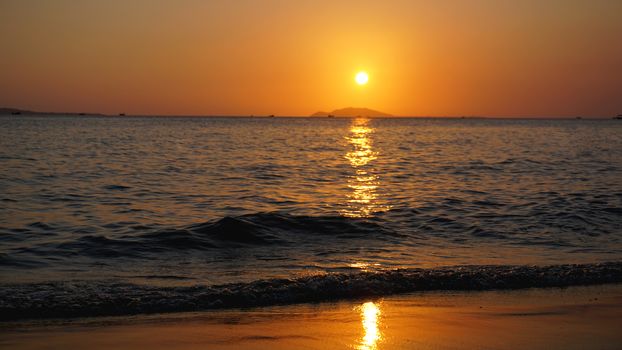Bright sunset with yellow sun under the sea surface - Summer vacation and nature travel adventure concept.