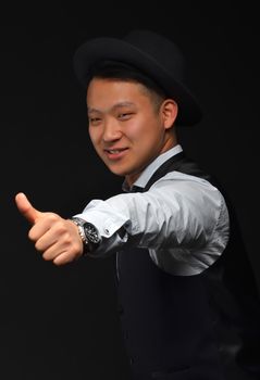 Young Asian man in shirt and jacket shows gesture "super" on camera