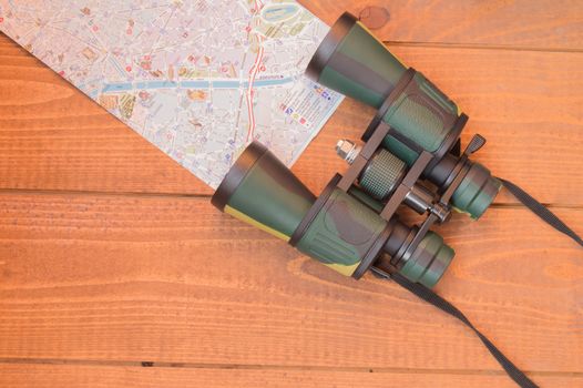 Travel planning, vacation tourism travel binoculars and map.
