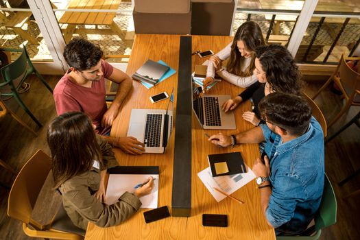 Groups of friends studying together on the bibliotech